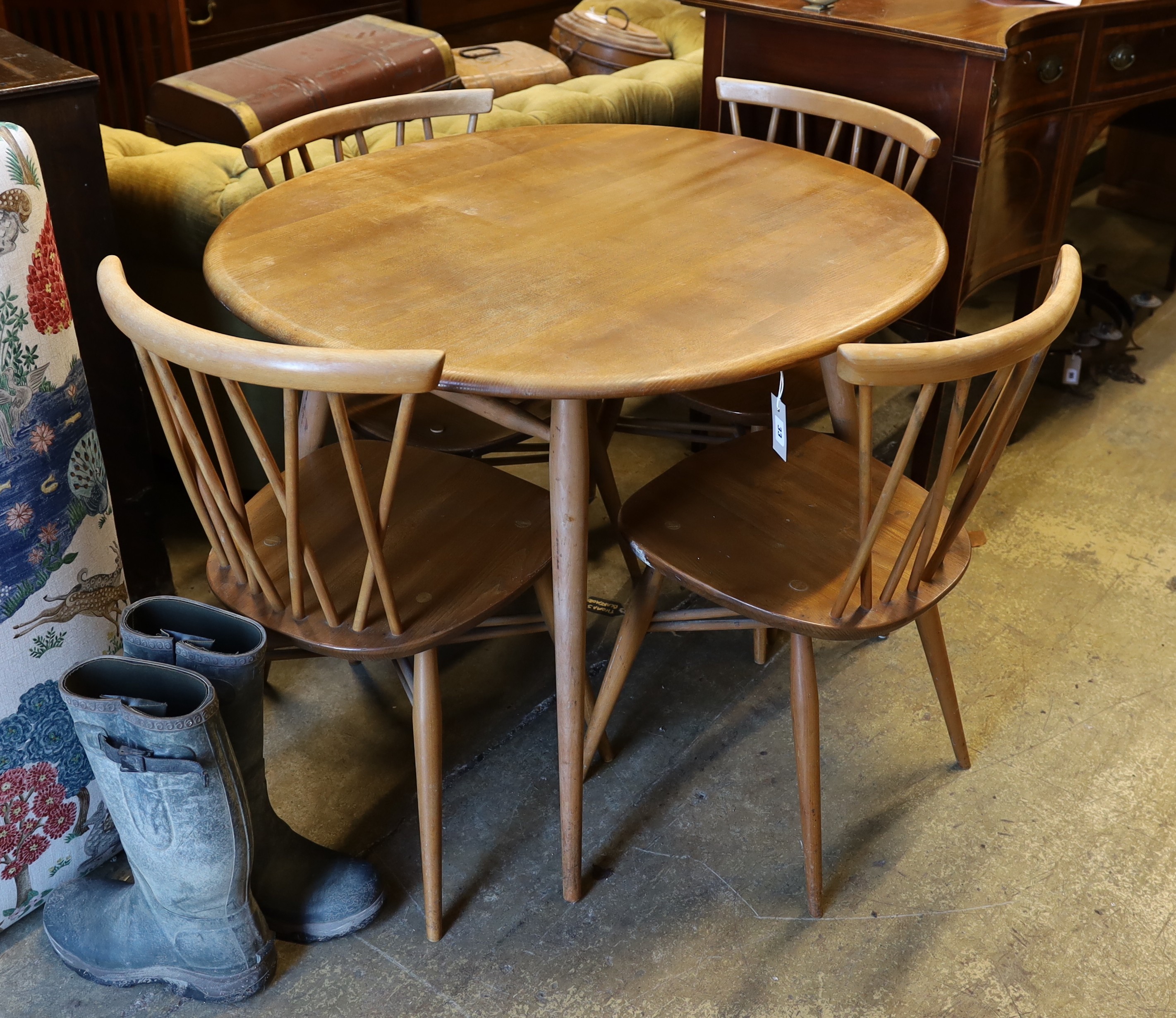 An Ercol elm and beech oval dining table, width 99cm, depth 89cm, height 71cm and four Chiltern chairs